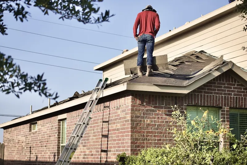 Professional roofer working on a residential roof in Countryside Manor